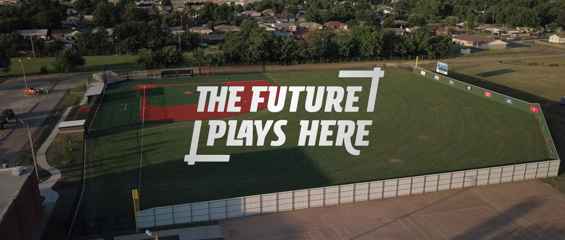 The Future Plays Here logo over an arial photo of Southeast High School's baseball field