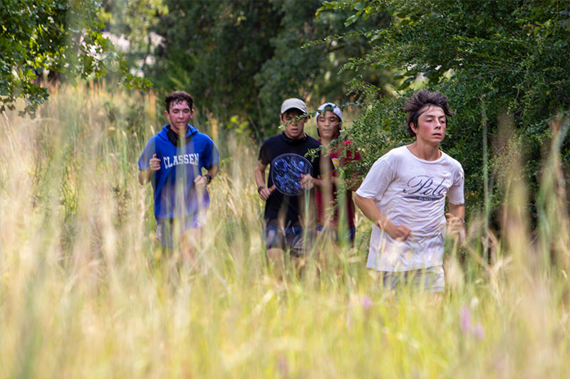 Cross-country runners from Classen SAS at Northeast High School running on a natural terrain course in Oklahoma City