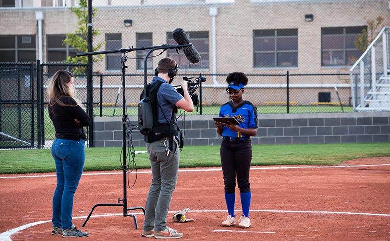 OKCPS student-athlete Symone Talley watching a video message from her parents Ayana and Duce Talley during filming of a Why We Care campaign video