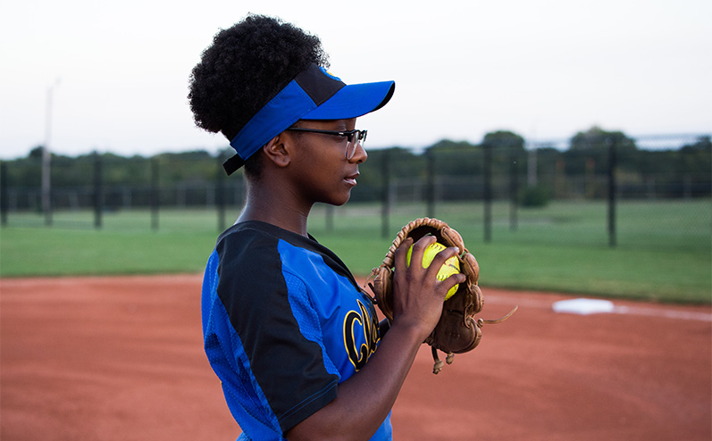 Classen SAS High School at Northeast student-athlete Symone Talley standing on the pitching mound of softball field