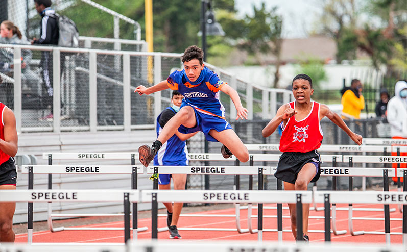 Fields & Futures All-City Track Meet Blog male middle school athletes competing in hurdles