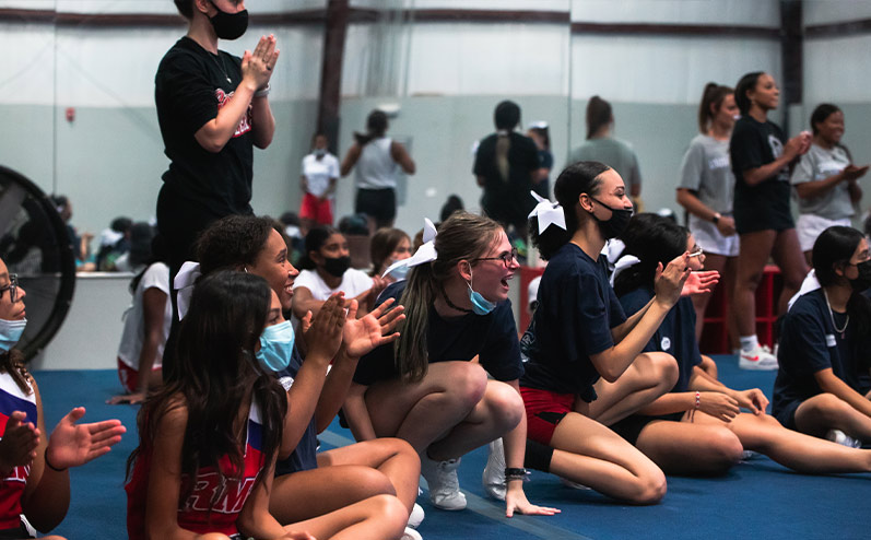 Fields & Futures blog 2021 OKCPS Cheer Clinic Wrap-Up story image of a group of cheerleaders laughing at cheer clinic